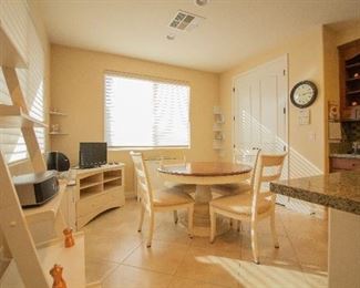 kitchen table with 4 chairs and media cabinet.