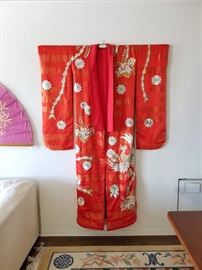 Large authentic vintage red Uchikake Ceremonial Wedding Kimono. Item was purchased in Japan. Heavily brocaded with intricate flowers and birds, and heavily padded along the hem. Hanging bar included. Dimensions are approximately 50" W x 72" H.

Category: Household & Estate > Antiques/Vintage