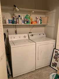 Washer & dryer and assorted cleaning supplies.