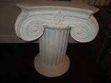 Off white pedestal features a round base with a beautifully scrolled top. The soft lines and traditional detailings of this stylized pedestal are certain to compliment any home!
