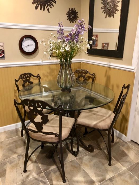 Round glass top dining table with iron base & 4 chairs - wall decor 