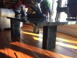 Utterly unique granite table.  Free-standing on 3 granite pillars this table will center a grand room.  