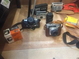 Cameras, film, tripods. 