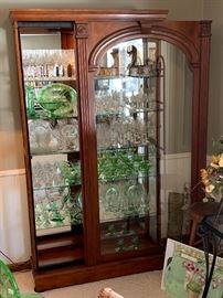 One of three beautiful slide front lit glass display cabinets