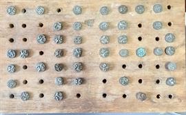 Antique railroad nails in wood pegboard 