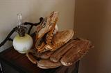2 soft ball mits and softball with an oil lamp