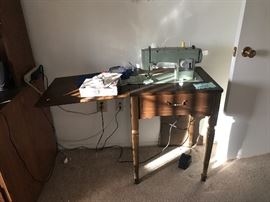 Vintage Kenmore sewing machine and cabinet. Sewing items.