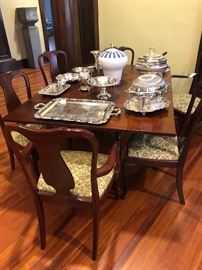 Drop leaf table open, set of 6 Queen Anne chairs, silver hollowware, including silver revolving covered roll server, large silver tray, chafing dish