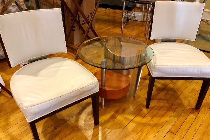 Pair of white leather chairs, metal and glass side table