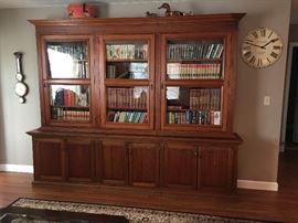 Large antique bookcase from Brazil. Base was made in the 80's, the top is much older (has wavy glass) but not sure exactly how old. Approximately 9 ft long, 7 1/2 ft tall, this is an impressive piece that gets lots of comments. Hate to let it go but I don't have a spot in my house for it. Has been modified a few times over the years to get it through doorways, etc. so it's not perfect. These mods make it possible to transport in (at least) 5 separate pieces. $2000