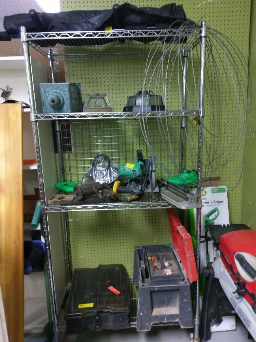 work box with tools, fishing tackle box with a number of lures, lights and saw.