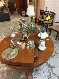 round dining table with leaf, lamps and household items.