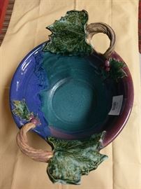 hand made clay bowl glazed with decorative leaves and handles.  has "Douglas 98" on bottom