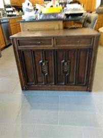 Saginaw Extendable Table Folds back into a cabinet. 