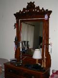 Eastlake bedroom suite consisting of dresser with mirror and matching bed.