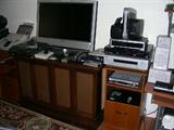 Bravia flat screen tv and other electronics on cabinet with bi-fold doors