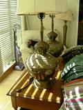 Pair of wonderful Indian table lamps. Another great floor lamp in the back next to the chair.