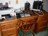 Desk, electronics, computer, printer, telephones.