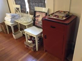 Small Red Cabinet - Metal, 2 white dining chairs, white end table, tray, misc glasses, tray, table linens.
