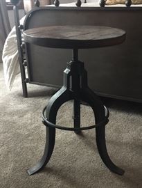 One of two swivel (piano) stools currently used as bedside tables - iron and wood