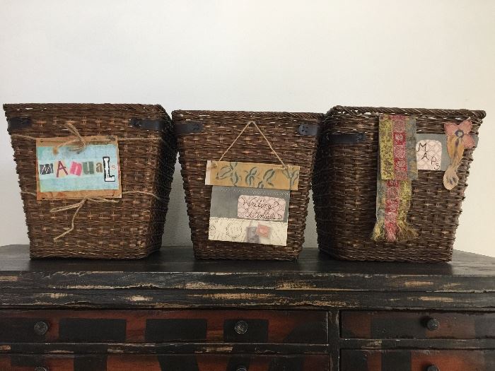 Three wicker baskets with leather accents