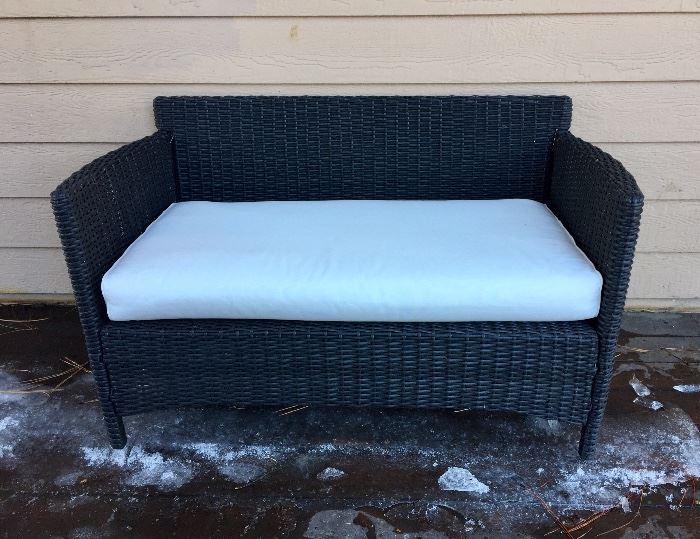 One of two outdoor "wicker" love seats
