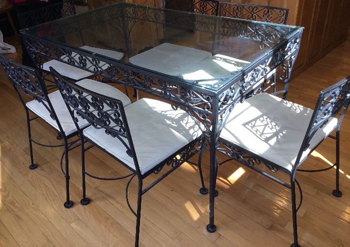 Beautiful Wrought Iron Table with Black Metal Lace Design and Six Matching Chairs, which are all padded. Great condition. 