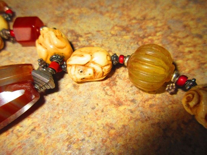 Detail of artisan necklace with monkey bead