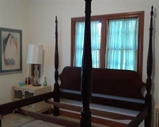 One of two four poster beds. One is king the other is queen