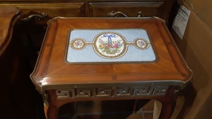 Beautiful porcelain inset design on small side table.