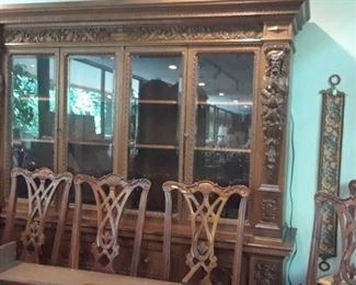 Large carved bookcase has been wired with lighting and can be used as a china cabinet. Shown are Chippendale side chairs. Fifteen are available but we have only five on display. Others can be picked up at UTSA.