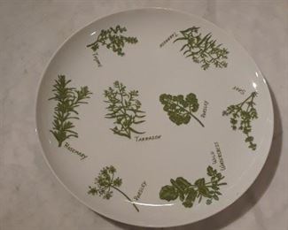 Eight dinner plates with herb design.