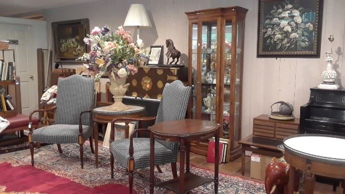 Pair of arm chairs and pair of tables with marble top and brass galley edges.