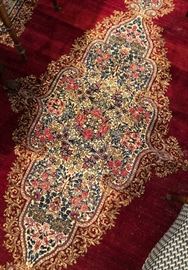 Detail of the center medallion of another rug with ruby color ground. 14 x 11 approximate size