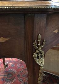 Ormolu trim on one of the parlor tables with inlay marquetry