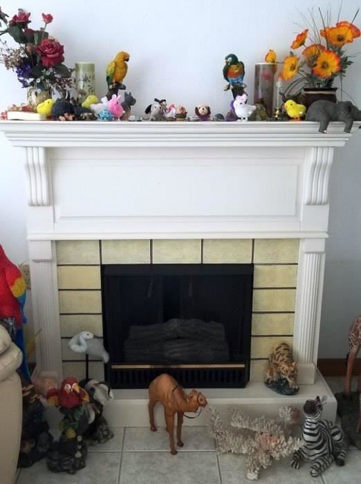 Freestanding electric fireplace (not tested yet) Misc. Parrot, bird, camel, zebra and tiger figurines. Silk plants. Sleeping elephant.  