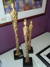 Three Tall Gold Statues