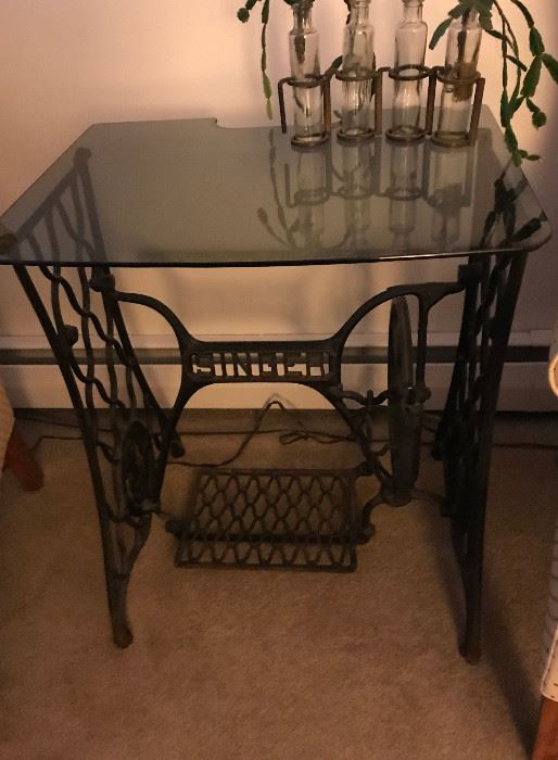 Converted sewing machine base with glass top table