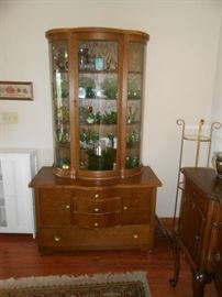 This beautifully curved front vintage cabinet is waiting to go home with you!
