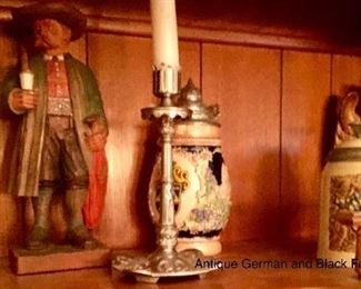 Black Forest carved figure pictured with beer steins 