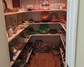 Butlers pantry full of serving pieces, china from around the world and collectible art glass and pottery