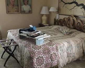 Large view of the master bedroom with a vintage bedspread shown on the foot of king bed and nice wicker bed tray table.