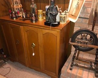 Custom made stereo cabinet with a matching cabinet housing a large speaker.  Round cabinet and square cabinet speakers were also part of the stereo system.   Music was piped into three rooms