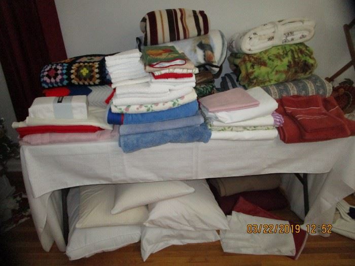 Table full of vintage and new and like new linens..