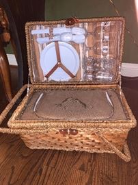 Picnic basket filled w/plastic ware and insulated bottom