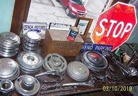 Old hub caps, hood ornaments, metal advertising cabinet, mirrors