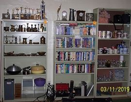 Office metal book shelves, Brass figurines, trophies, steins, DVD's, VHS, video games, etc....