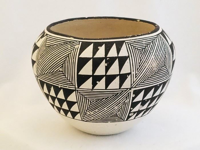 4" tall and 5 1/2" in diameter. Signed by Marie Z. Chino (one of the matriarchs of the Acoma Pueblo pottery family. She is credited with reviving the pottery tradition at the pueblo in the mid 20th century. The piece has numerous spots of "spalling" (where moisture in the underlying clay has expanded and popped off a bit of the glaze over it )  This was common in Acoma Potttery produced during this time period due to the clay the potters used. 
