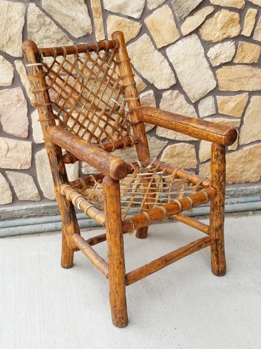 Peeled log and snowshoe weave rawhide chair from the historic Leeks Lodge in Jackson, Wyoming.