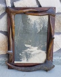 Stephen N. Leek photograph of a waterfall in a frame with elk antler points from the historic Leeks Lodge in Jackson, Wyoming.